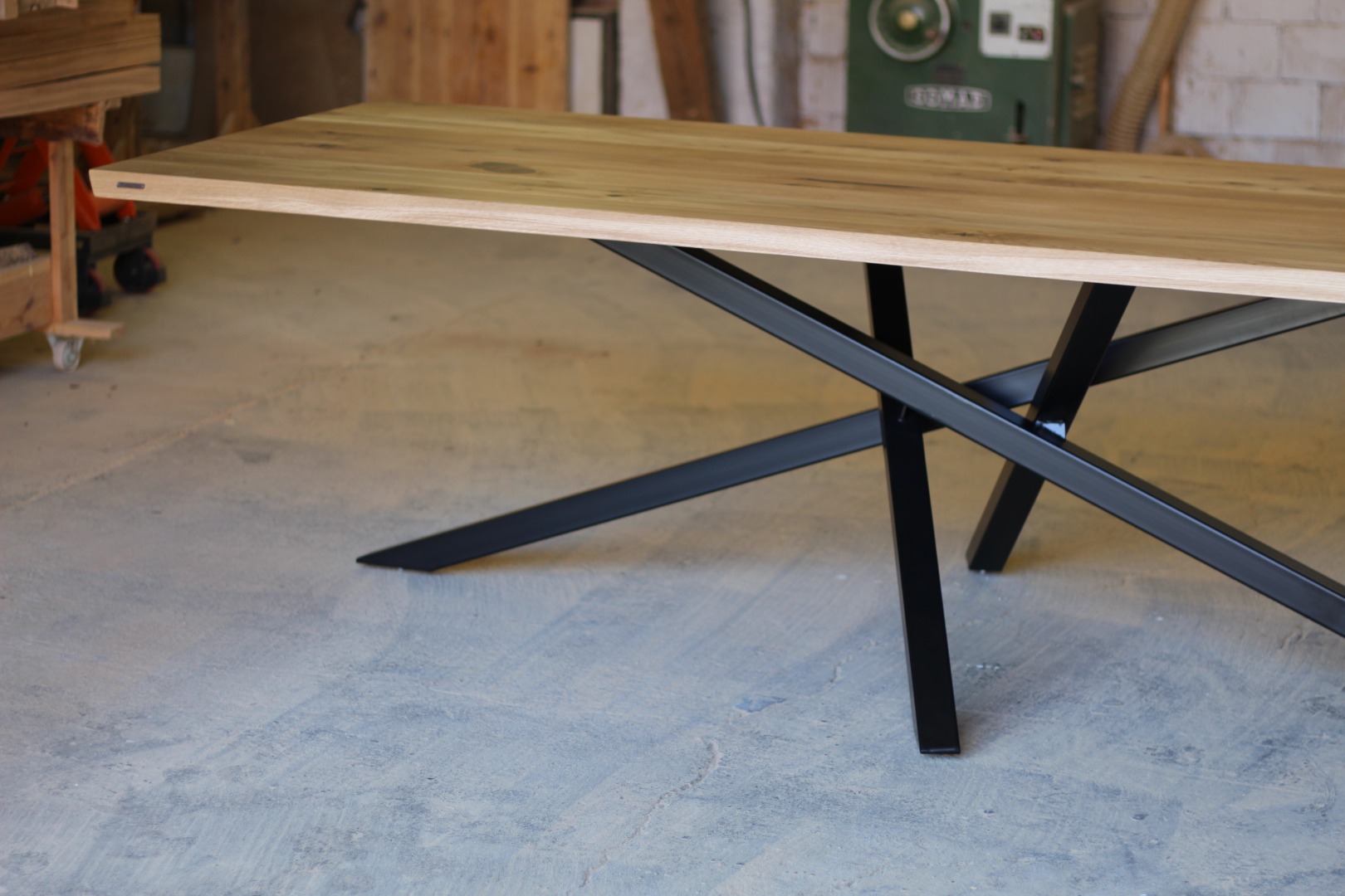 Large rustic timber dining table with black metal legs